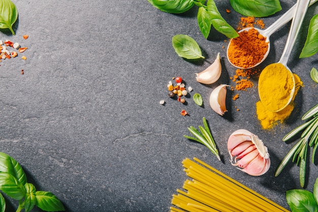 Ingredients for cooking placed on dark background.