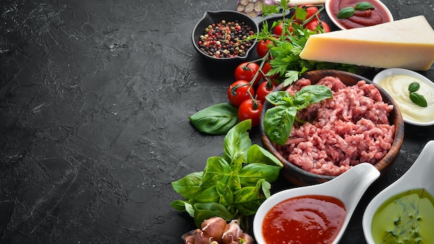 Ingredients for cooking sauce Bolognese On a black background Top view Free space for your text