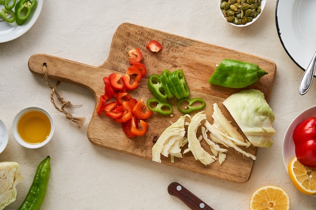 Ingredients for cooking vegetable salad on a wooden cutting board