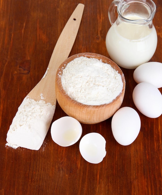 Ingredients for dough on wooden table closeup