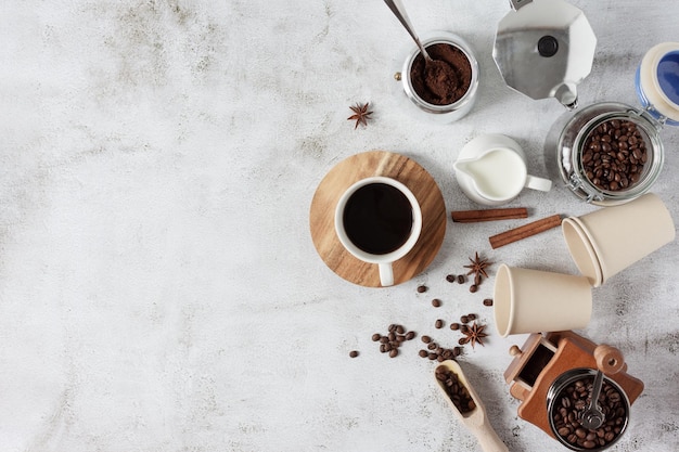 Ingredients and equipment for making coffee top view on grey background