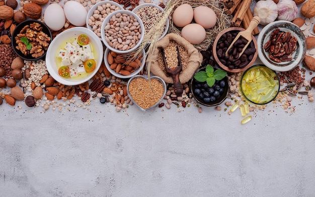 Ingredients for the healthy foods selection The concept of superfoods set up on white shabby concrete background with copy space