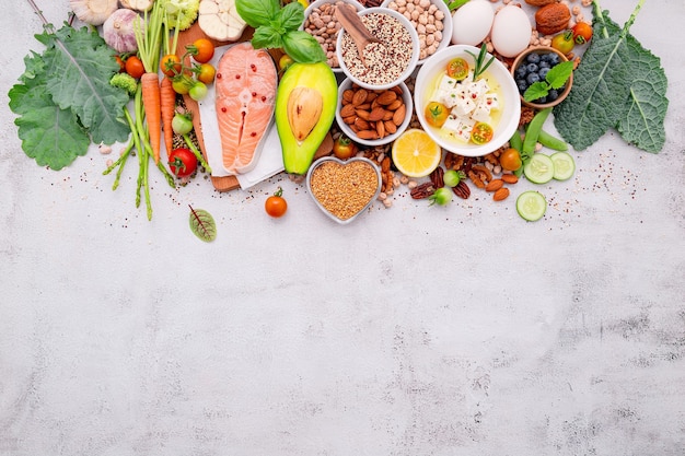 Ingredients for healthy foods selection set up on white concrete