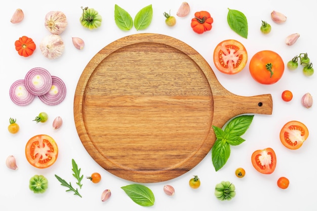 The ingredients for homemade pizza set up on white concrete background