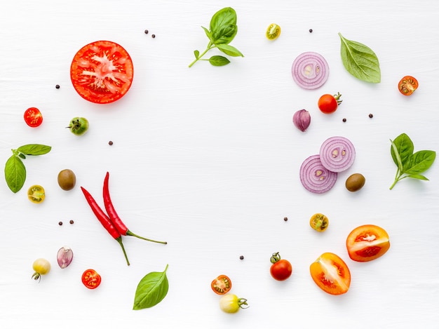 The ingredients for homemade pizza on white wooden background.