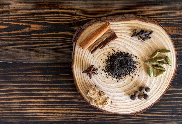 Ingredients for indian masala tea on wooden background High quality photo