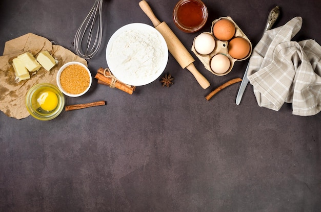 Ingredients for making dough dishes cakes cookies muffins pies on a dark background