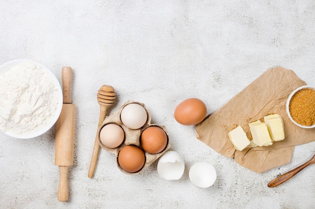 Ingredients for making dough dishes cakes cookies muffins pies on a gray background