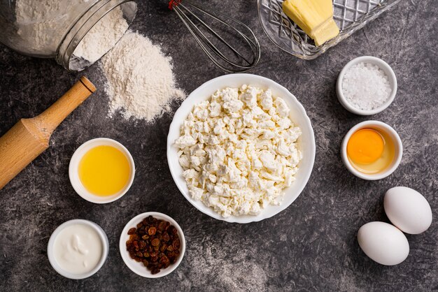 Ingredients for making homemade cheesecakes. Bakery background top view.