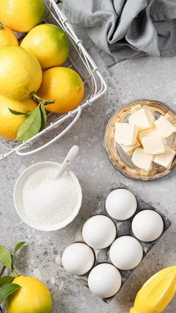 Ingredients for making a pie with lemon curd and blueberries on a white stone table