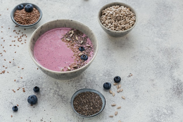 Ingredients for making pink yogurt smoothie bowl with blueberry and seeds