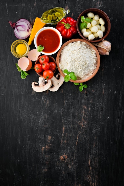 Ingredients for making pizza On a wooden background Top view Free space for your text