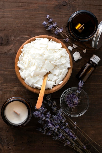 Ingredients for making soy candles on a wooden background.