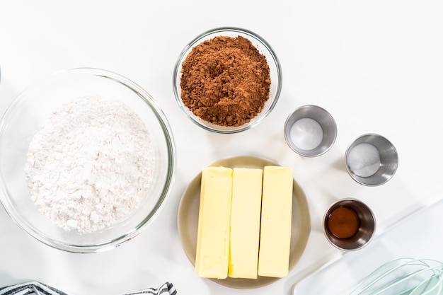 Ingredients in mixing bowls on the counter to bake chocolate cookies