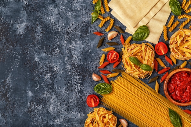 Ingredients for pasta on a dark table