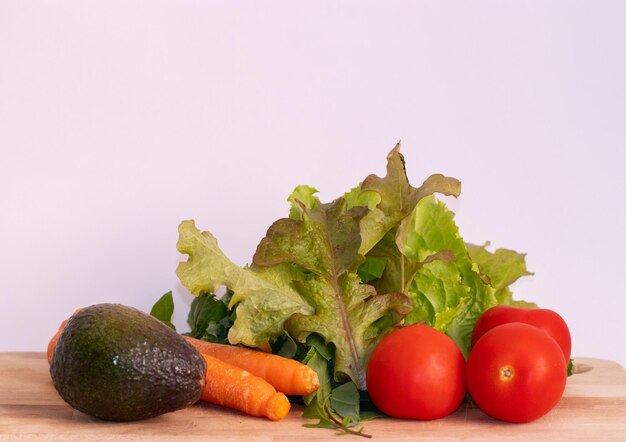 Ingredients to prepare a salad lettuce tomatoes avocado and carrots