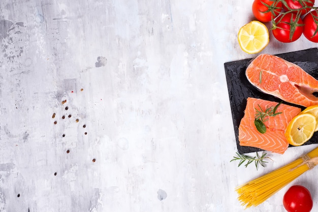 Ingredients for preparing pasta and sauce isolated on stone background.