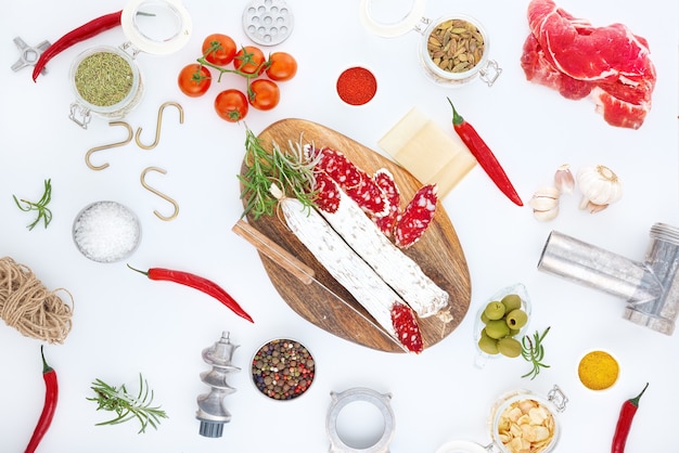 Ingredients of the production of cured sausage from the raw material to the finished product. Isolated on white.