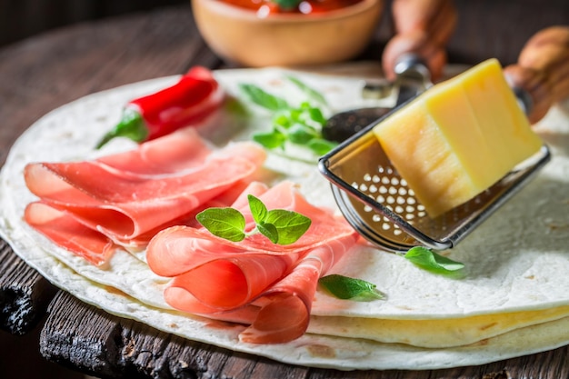 Ingredients for quesadilla made of tortilla ham and cheese