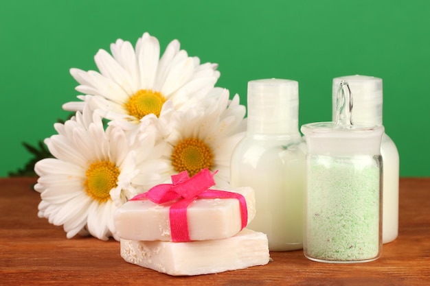 Ingredients for soap making on green background