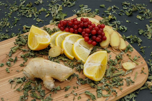 Ingredients for tea. Lemon, ginger, mint and viburnum. Pieces of lemon. Tea in the cold season.