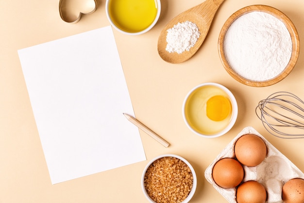 Ingredients and utensils for baking on a pastel background, top view.