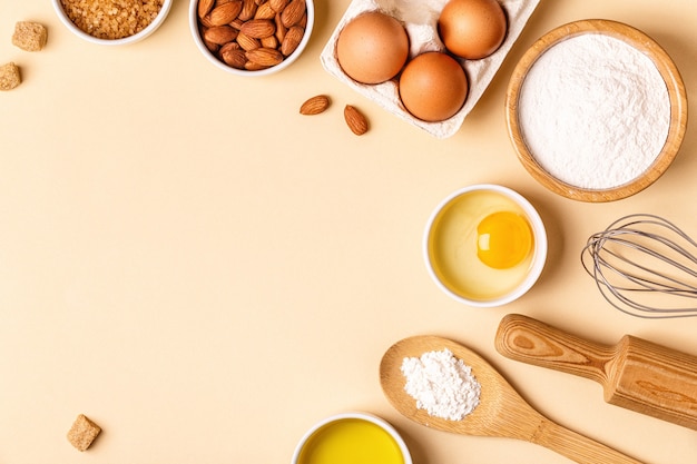 Ingredients and utensils for baking on a pastel background, top view.