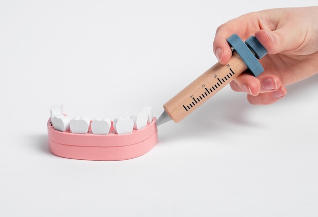 Injecting anesthetic medicine in jaw gum with syringe Teeth treatment with local anesthesia