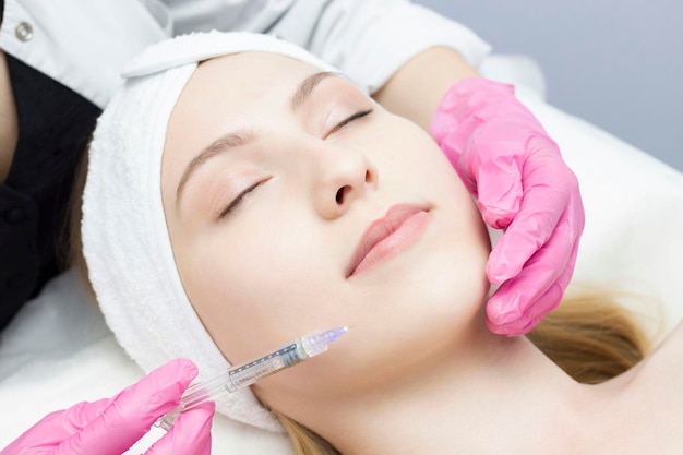 Injection in the face at the spa salon The doctor's hands Biorevitalization Facial care with hyaluronic acid