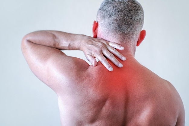 Injury of the cervical spine a man with back pain at home Myalgia arthritic joint pain