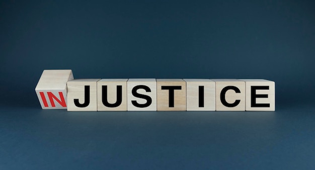 Injustice or justice Cubes form the choice words Injustice or Justice