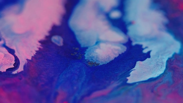 Ink spill glitter fluid flow defocused neon blue pink color shimmering texture liquid paint blend