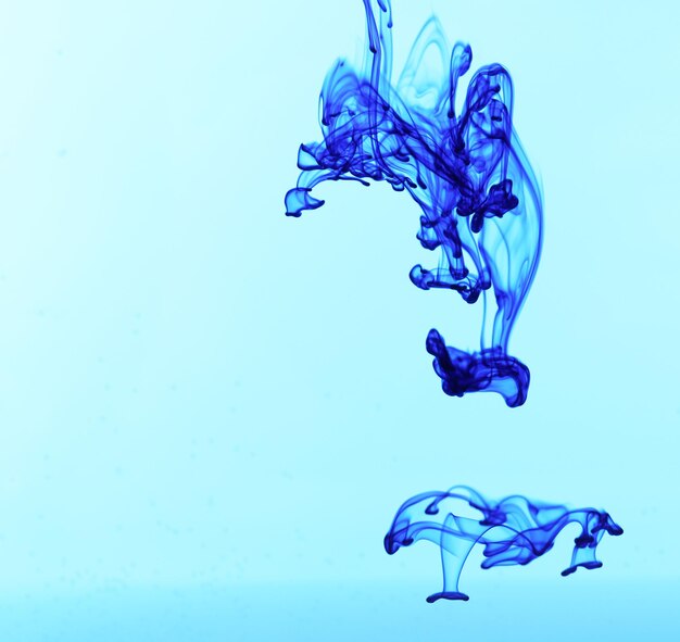 Ink in water on blue background