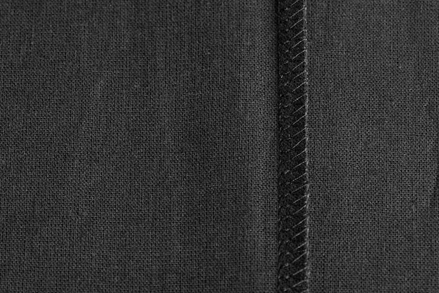 Inner sewing seam on black linen cloth, as background