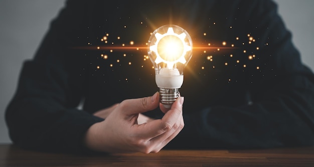 Innovation design concept Hand holding light bulb for new idea brain storming creative inspiration