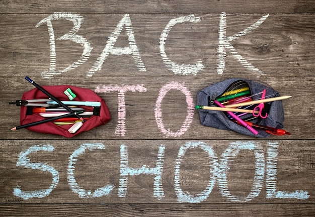  Inscription back to school and two pencil-cases with school accessories