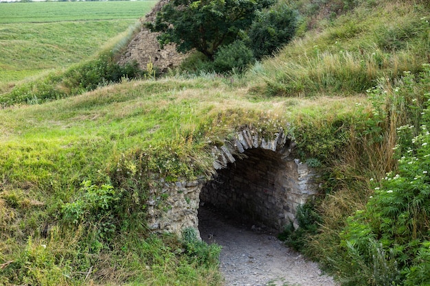 The inscription of the city of Khotyn on the background of a green field near the castle. Translation: Khotin