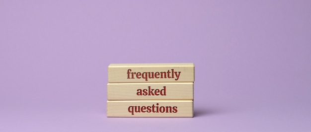 Inscription frequently asked questions on wooden blocks on a purple surface