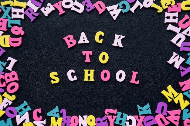 Inscription from colored wooden letters on chalkboard