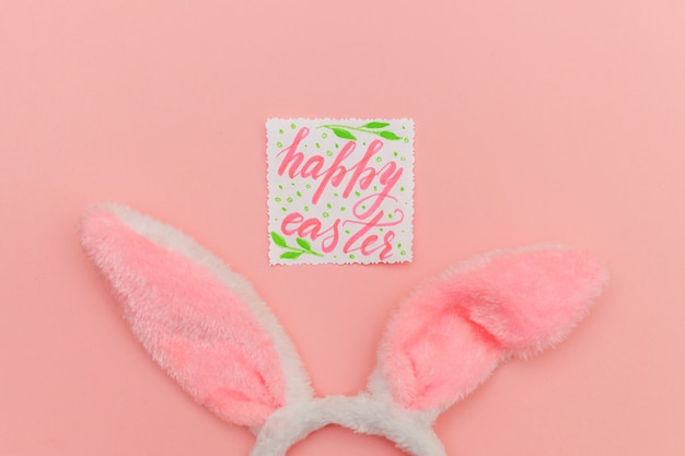 Inscription HAPPY EASTER letters and decorative bunny ears