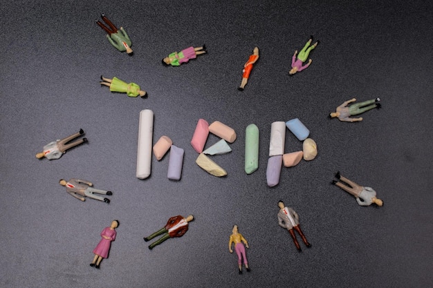 The inscription on the help of colored chalk beside people figurines