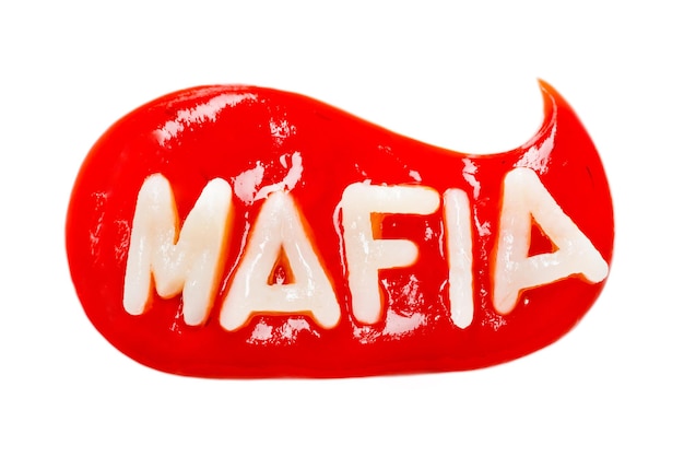 Inscription MAFIA made from pasta in a drop of red ketchup on a white background Isolated