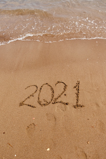 Inscription on the sand  symbol  on the coast overlooking the sea summer holidays in the new season