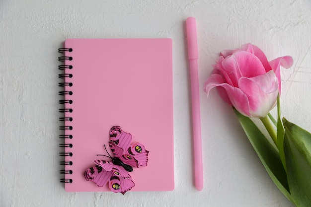 Inscription spring flowers and notepad on a white background