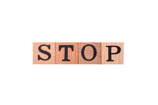 The inscription stop on wooden cubes on a dark concrete background