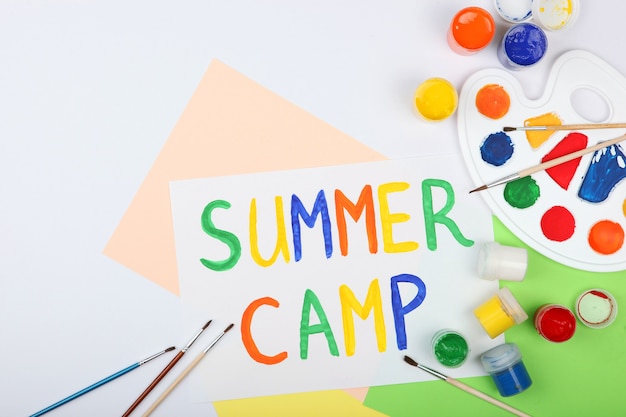 The inscription summer camp on a colored background top view