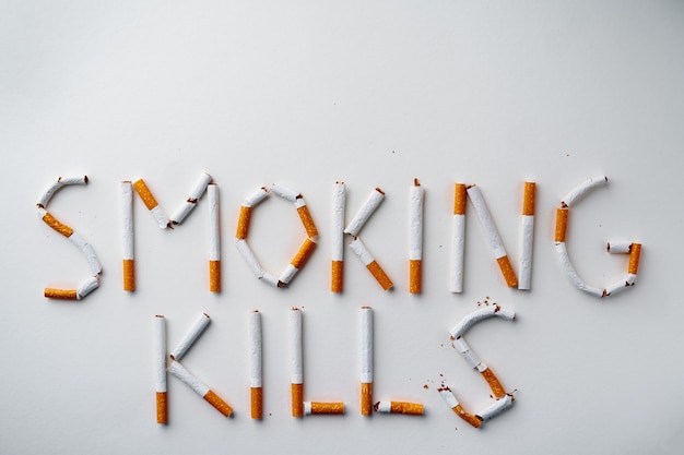 Inscription word SMOKIN KILLS made out of cigarettes top view