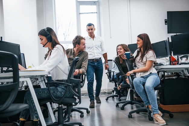 Inside of call center. Young business people working together in the modern office.