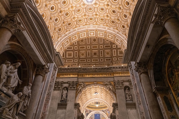 The inside of a church with a dome and a lot of statues