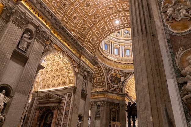 The inside of a church with a gold ceiling and a dome